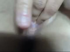 A pretty blonde girl fingering and toying with her hairless snatch